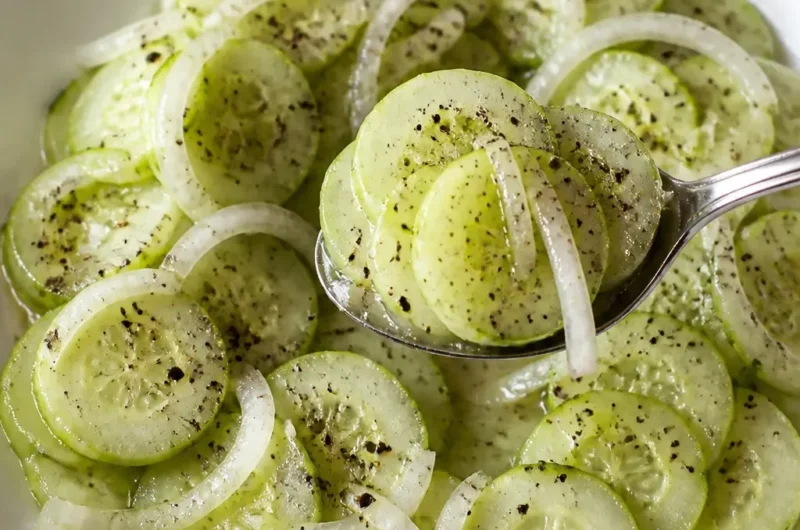 Gurkensalat mit Essig und süßer Zwiebel auf einem Teller
